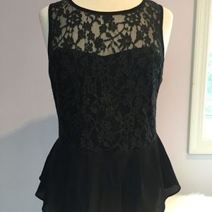 Black peplum top with subtle gold detailing